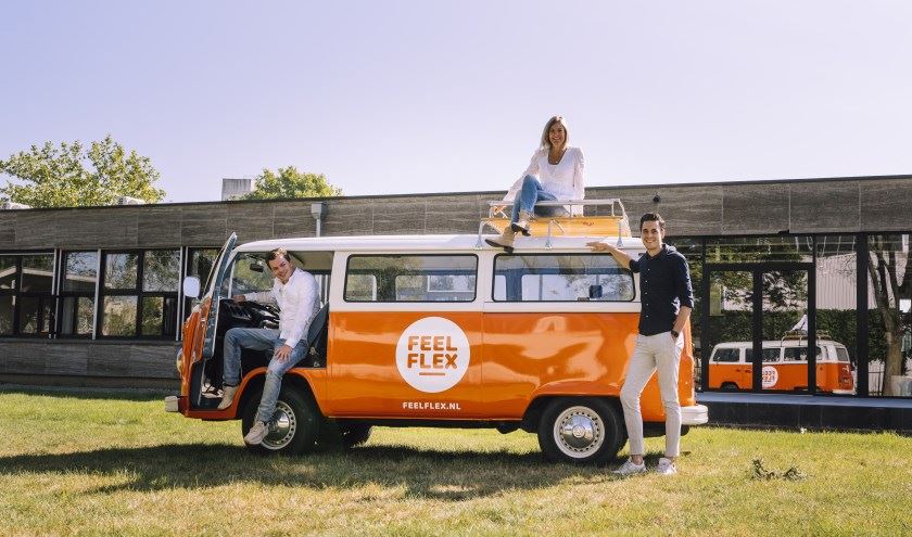 Foto van het Feel Flex-team buiten in een VW-busje