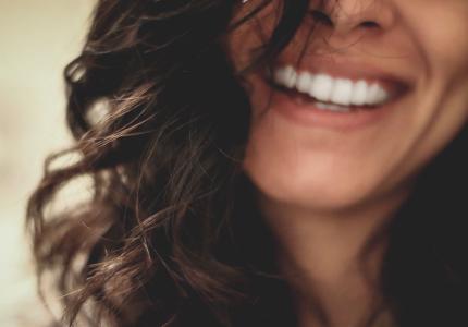 Frau lächelt mit entblößten Zähnen